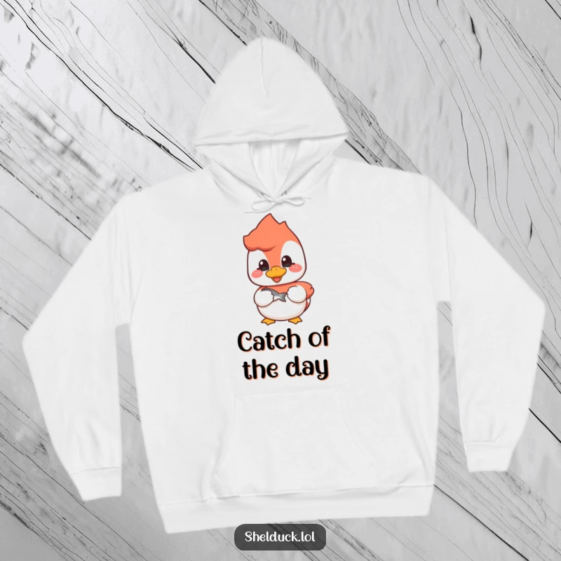 Funny shelduck hoodie depicting a cheerful bird holding a fish, ideal for anglers and cold weather.