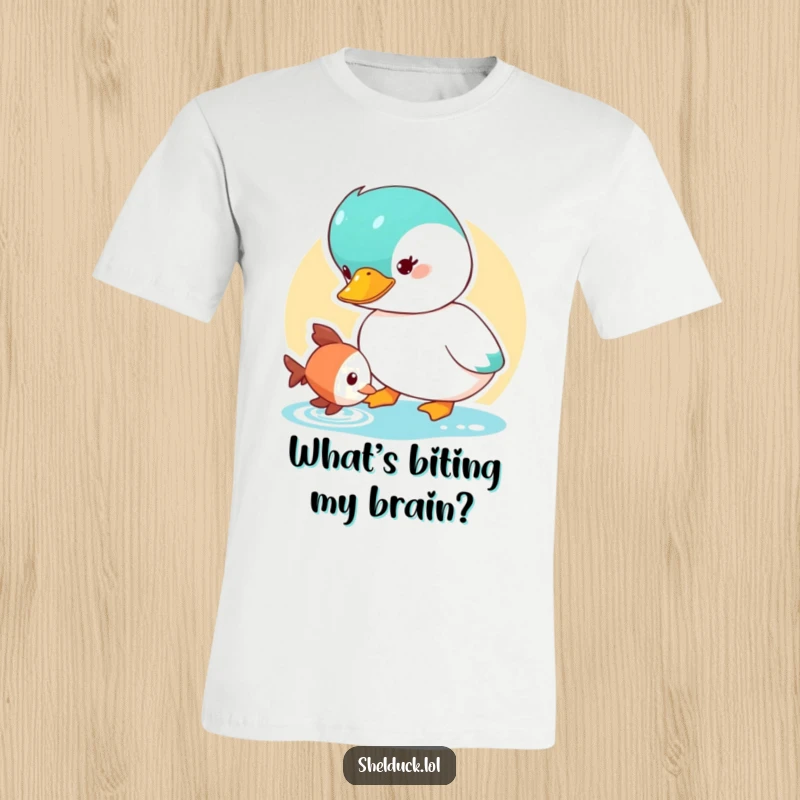 Funny Shelduck T-Shirt depicting a cute duck character curiously looking at a small fish, ideal for nature lovers.