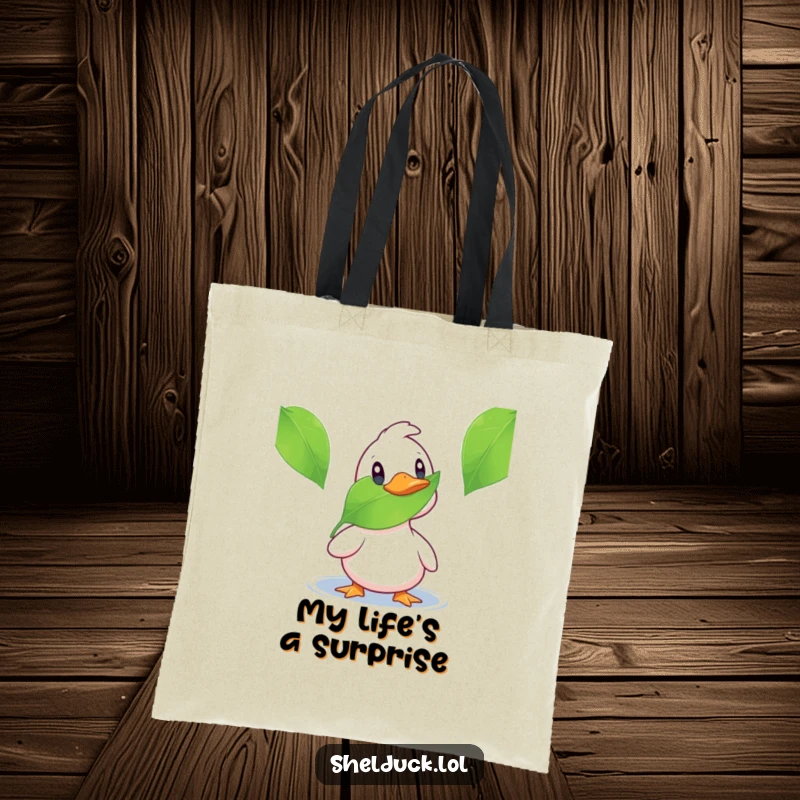 Funny shelduck tote bag featuring a duck looking surprised by a leaf, great for shopping and humorous personal style.